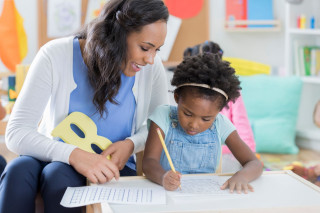 Child-care-worker-helps-little-girl-with-handwriting-886934186_6720x448_20200610-124753_1